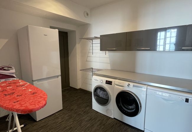 Laundry room with washing machine, tumble dryer, large fridge