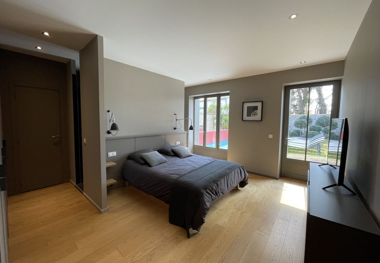 Bright master bedroom with wooden floor