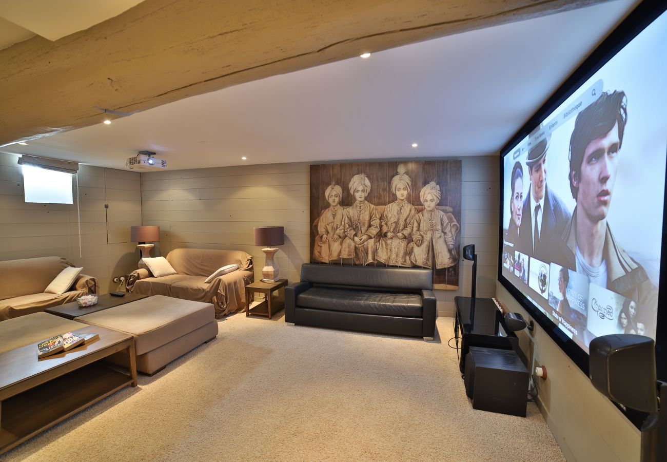 Home cinema with sofas and large TV screen 