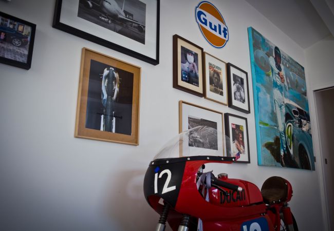 White wall with decorative frames and motorbike