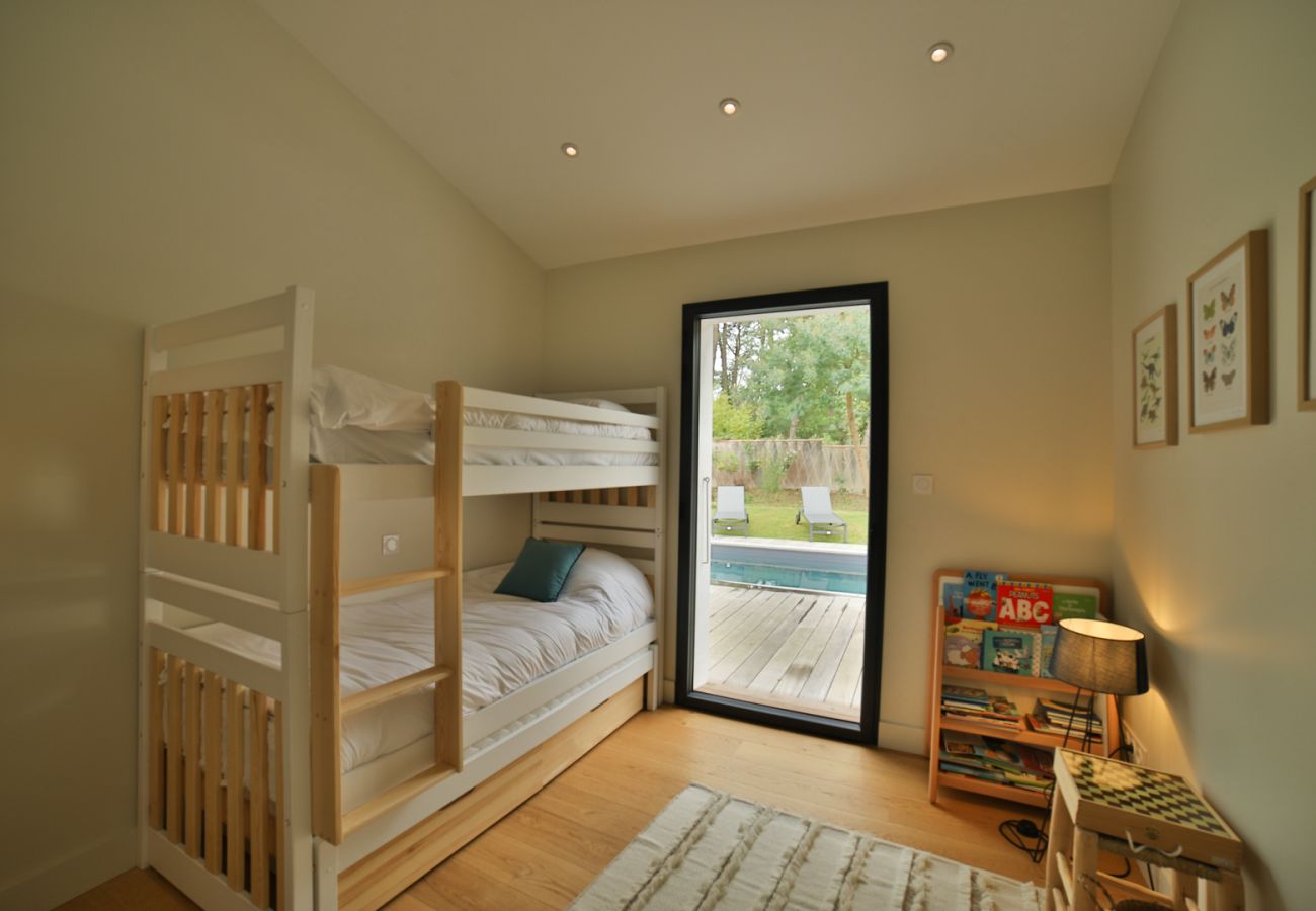 Children's room with bunk beds and pool view