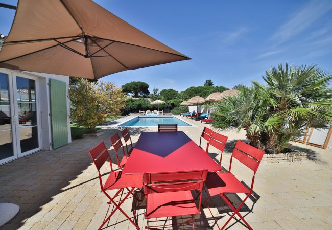 Outdoor dining table with chairs and large parasol 