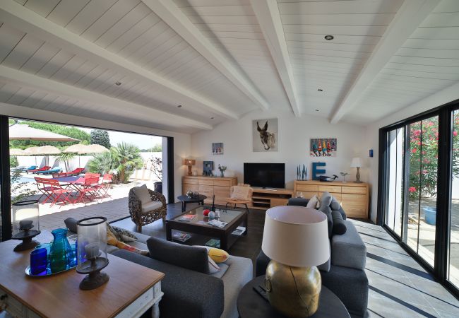 Living room with large sofas, television and view of the garden