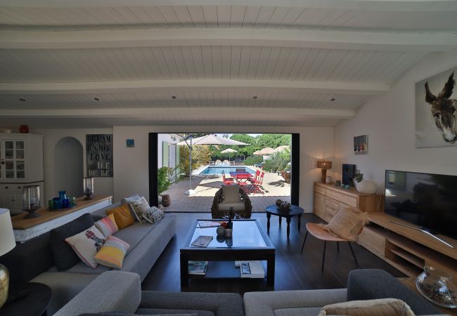 Living room with large sofas, television and view of the garden