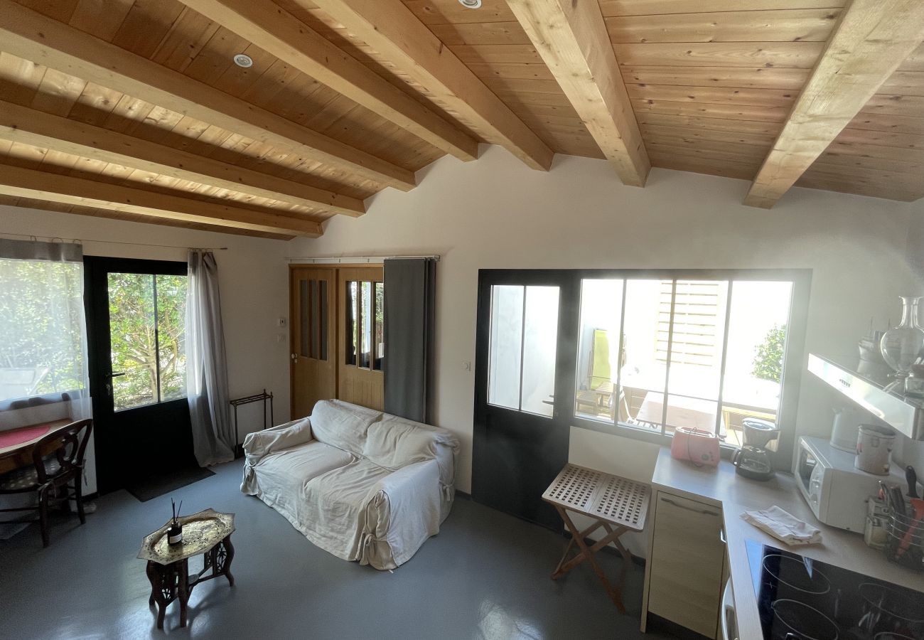 Bright living room with sofas, small table, and beamed ceiling 