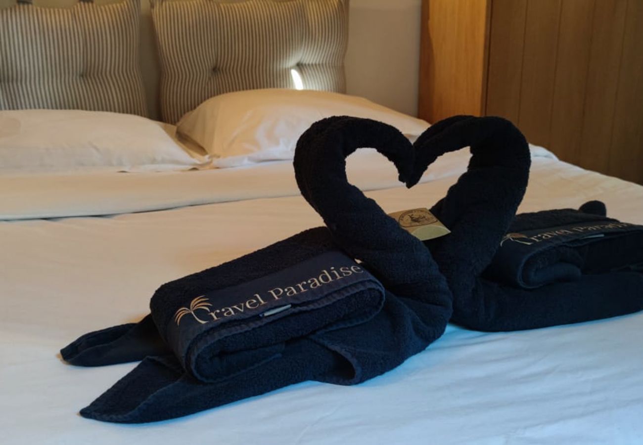 Double bed with Travel Paradise heart-shaped folded towels 