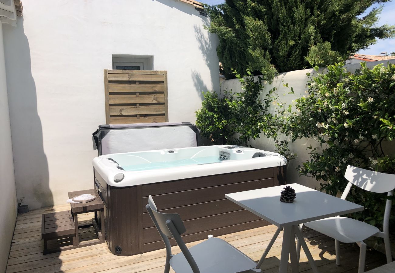Wooden terrace with table and chairs and hot tub