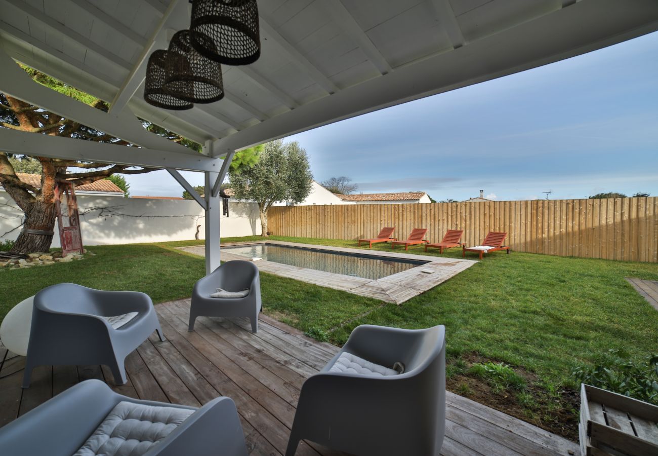 The covered outdoor lounge by the pool