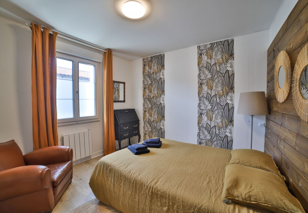 Bedroom with double bed and leather armchair