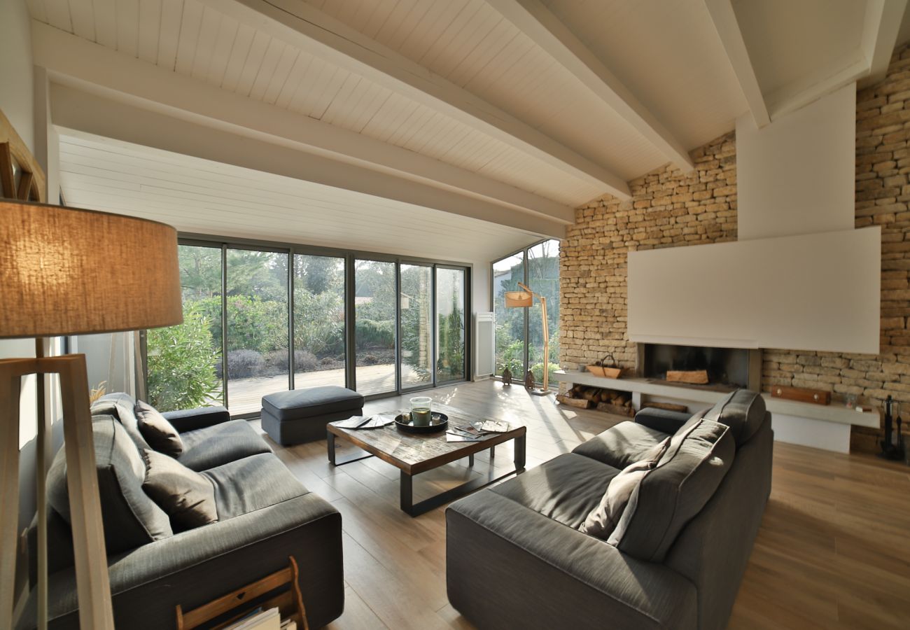 The bright living room with sofas, coffee table and large windows 