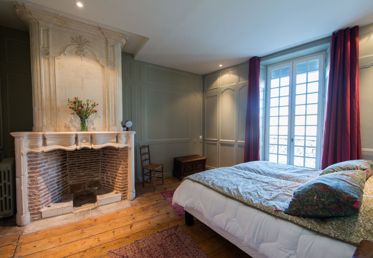 Bedroom with double bed and large fireplace 